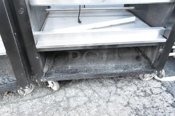 Vulcan 1013776 metal commercial bakery display rack on casters, shows signs of use, ideal for pastries or donuts.