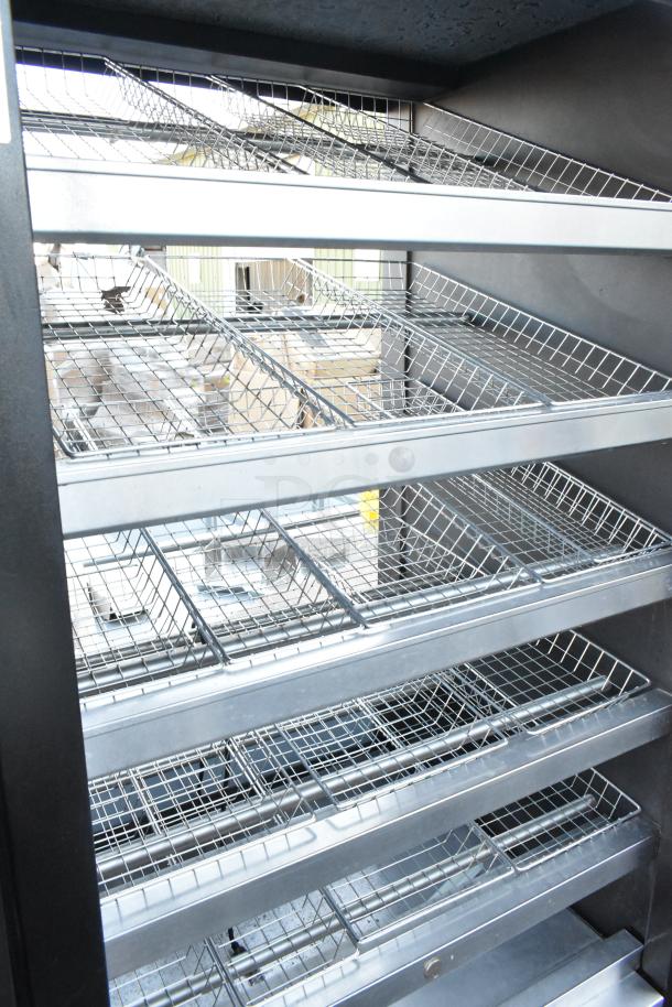 Vulcan 1013776 metal commercial bakery display rack with wire shelves and commercial casters, excellent condition.