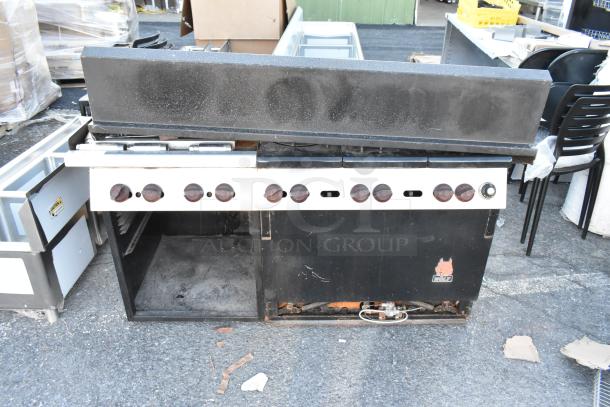 Wolf Metal Commercial Gas Range, featuring 6 burners, flat top griddle, oven, backsplash, and over shelf. Signs of use evident.