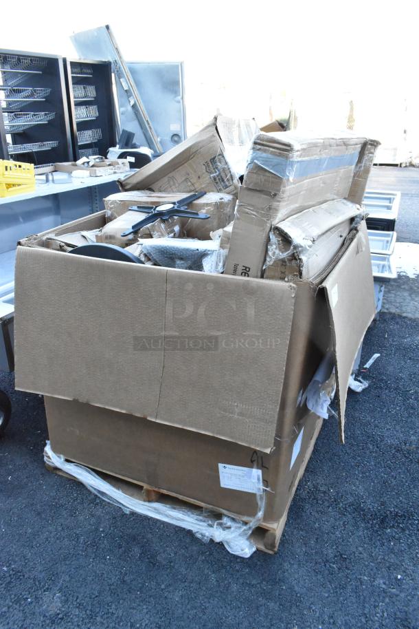 Large pallet with 18 new scratch and dent items including a work table and cutting boards. Visible packaging and labels.