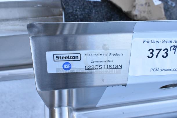 Brand new Steelton 522CS11818N stainless steel single bay sink, scratch and dent, no legs, NSF certified label visible.