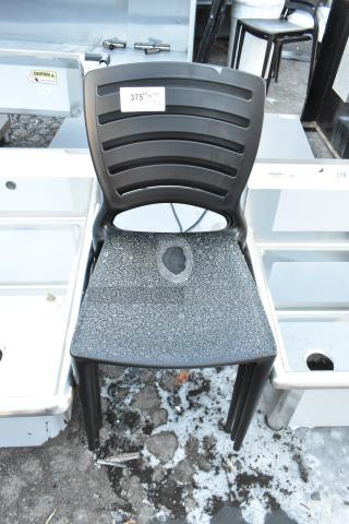Black poly chair with slatted back, visible seat damage, labeled “375 1/2/39 QTY x3.” Scratches visible.