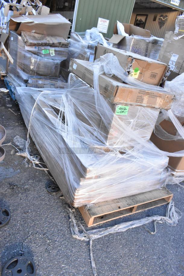 Pallet with 7 new scratch and dent items wrapped in plastic, includes sink, folding table, and work table. Boxes marked "Skid 134."