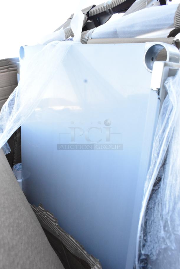 18 new scratch and dent items including chairs and work table, partially unpacked with protective wrap.