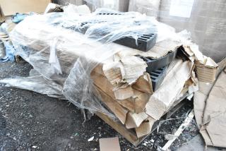 Five black poly shelf pieces, brand new, scratch and dent condition, wrapped in plastic, cardboard packaging, on a pallet.