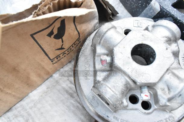 Set of new scratch and dent items including a black poly shelf piece and metallic component marked "P603W-1."