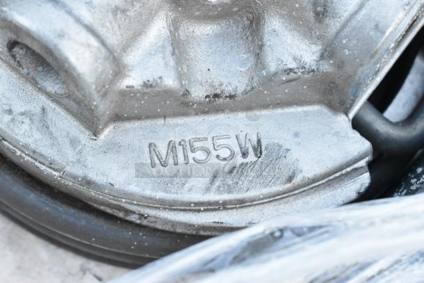 Metal component with visible marking "M155W." Part of a lot of five brand new scratch and dent items, including black poly shelf pieces.