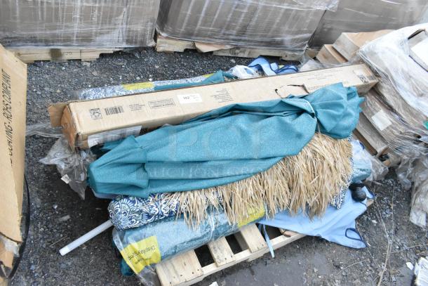 Pallet lot of assorted items including a teal patio umbrella, boxes, and packaging. Items appear new and boxed.
