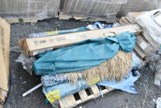 Pallet lot of assorted items including a teal patio umbrella, boxes, and packaging. Items appear new and boxed.