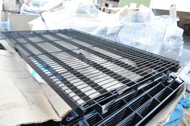 Pallet lot of brand-new black metal wire racks, slightly scratched. Ideal for storage, durable construction.