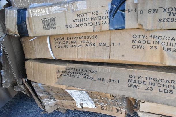 Stack of cardboard boxes labeled with UPC 847254056328, color natural, and made in China. Each weighs 23 lbs. Boxes contain scratch and dent items, including table bases and cocktail tables.