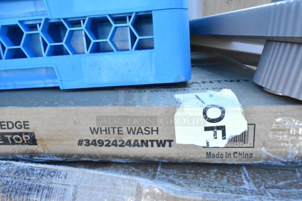 Cardboard box labeled "WHITE WASH #3492424ANTWT, Made in China" under blue plastic crate and metal parts. Appears new.