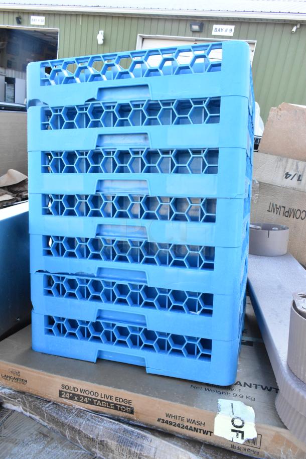 Stack of blue plastic racks beside a Lancaster table top box labeled "Solid Wood Live Edge 24"x24", White Wash."