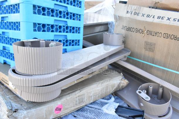 Alt text: "Assorted new scratch and dent table bases and cocktail tables. Includes visible packaging and protective materials."