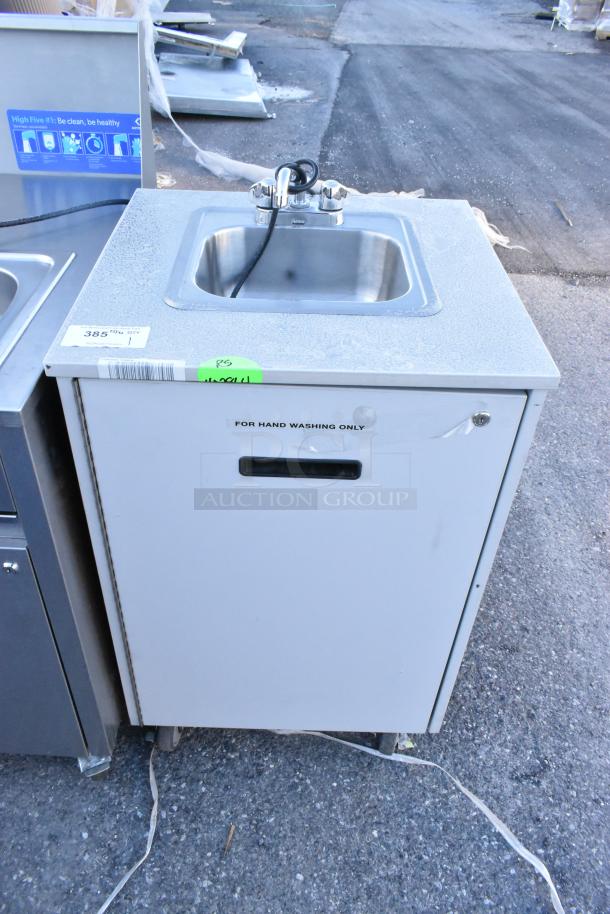 Stainless steel portable sink on commercial casters, with faucet. Label reads "For hand washing only." Mint condition.