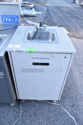 Stainless steel portable sink on commercial casters, with faucet. Label reads "For hand washing only." Mint condition.