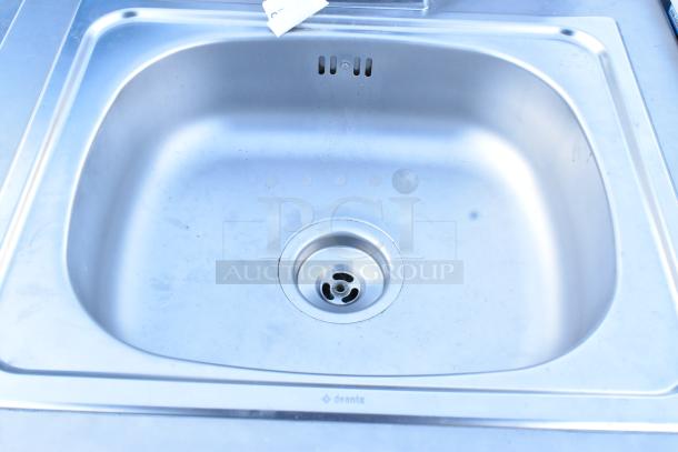 Stainless steel portable sink by QualServ with commercial casters, 120V, 1 phase. Sink shows minimal wear.