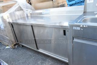 Win-holt stainless steel counter with two sliding doors, under shelf, and commercial casters. Good condition. Suitable for commercial use.