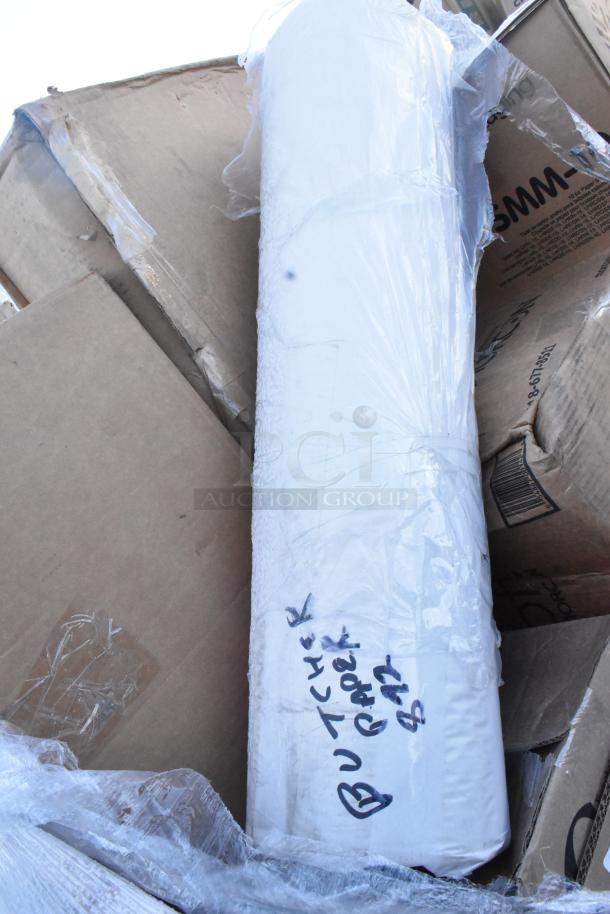 Roll of butcher paper wrapped in plastic, labeled "Butcher Paper B12," set on damaged cardboard.