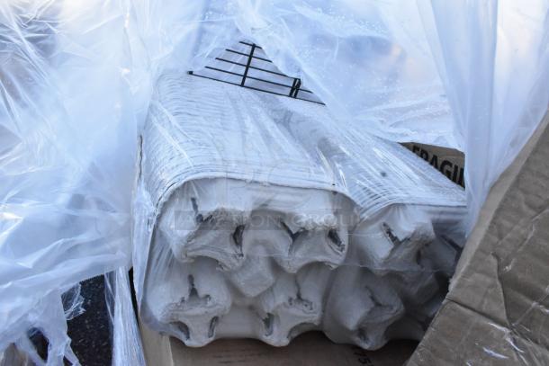 Plastic-wrapped stack of cardboard trays marked "FRAGILE," included in a lot of 15 scratch and dent household items.