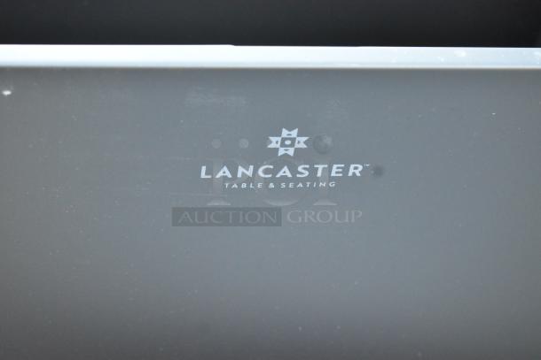 Brand new Lancaster Table & Seating black trash can with minor scratches. Visible logo enhances its authenticity.