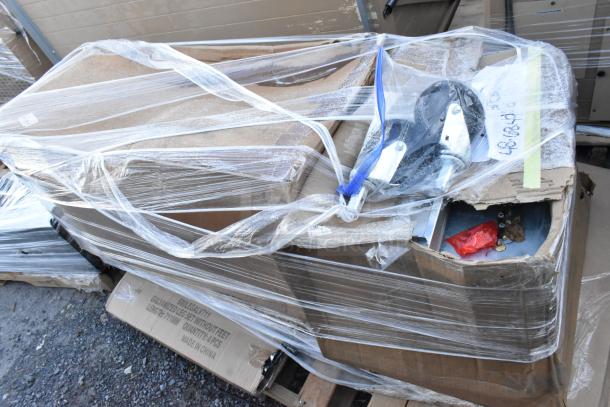 Four brand new scratch and dent items, including a bun rack and ladderback chair frame. Items wrapped in plastic, some packaging visible.