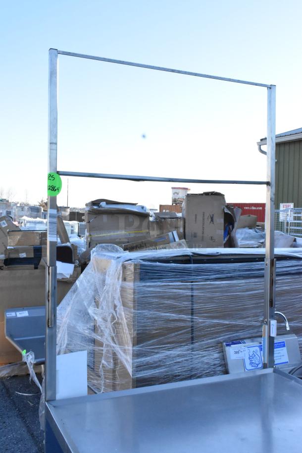 Stainless steel table with under shelf and drawer, on commercial casters. Tag indicates item number RS 03864. Good condition.
