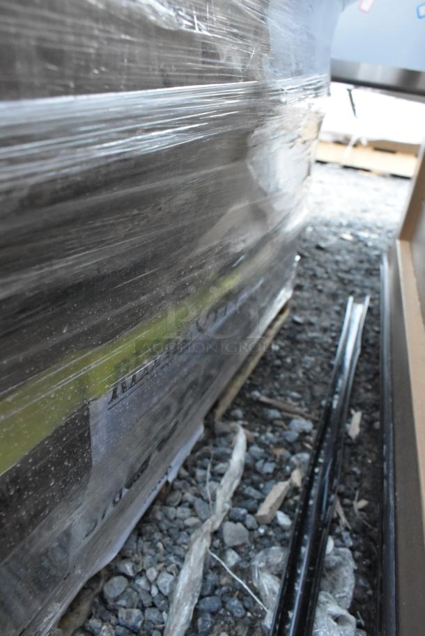 Six brand new scratch and dent items wrapped on a pallet, including over shelf and wire shelf components.