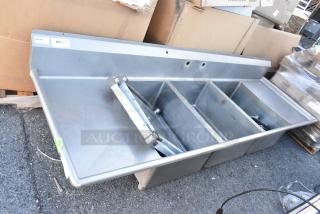 Winholt stainless steel 3-bay sink with dual drain boards, no legs. Features include durable construction and multi-compartment design.