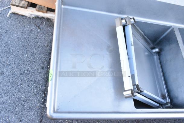 Winholt stainless steel 3-bay sink with dual drain boards, no legs; industrial design, suitable for commercial use.