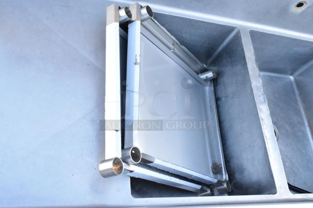 Winholt stainless steel 3-bay sink with dual drain boards, no legs. Features durable construction, ideal for commercial use.