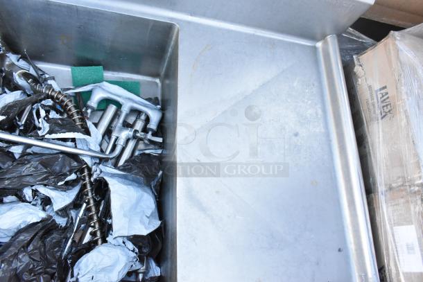 Winholt stainless steel 3 bay sink with dual drain boards, no legs, used condition, visible hardware, and packaging material.