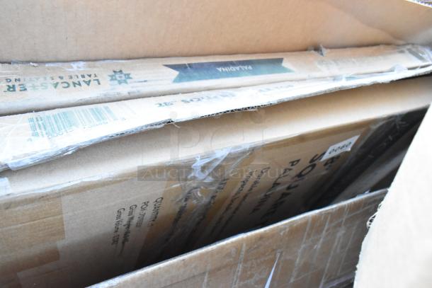 New scratch and dent items in boxes include Lancaster table seating equipment and tabletop filler. Barcodes and labels visible.