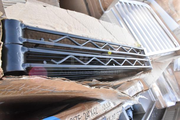 Brand new scratch and dent items, including black metal equipment filler table, tabletop grills, in shipping boxes.