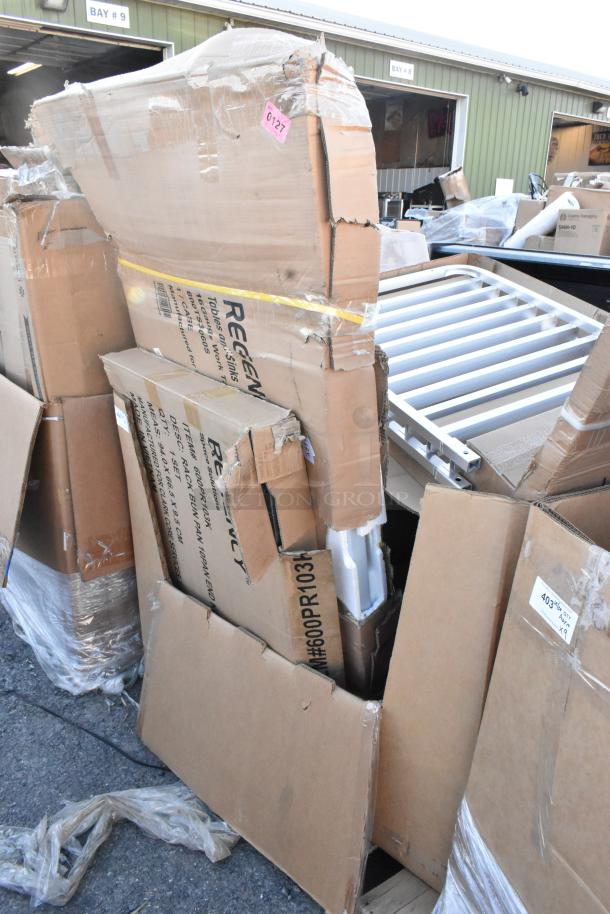 Seven new scratch and dent items, including bun rack and work table in damaged packaging. Item code #0127 visible.