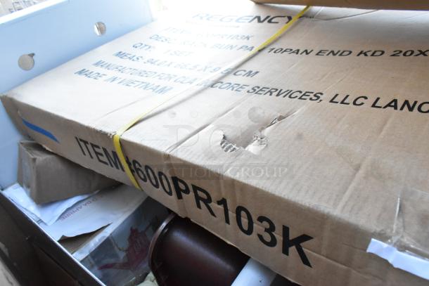 7 brand new scratch and dent items including bun rack, work table, cooler cart in boxes. Some packaging slightly damaged.