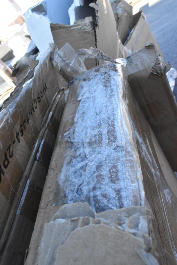 Damaged cardboard boxes containing scratch and dent items, including wire shelves and folding chair, torn packaging visible.
