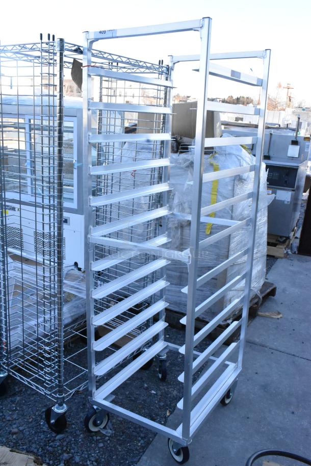 Metal commercial pan transport rack with multiple slots, on heavy-duty casters, suitable for bakery or restaurant use.
