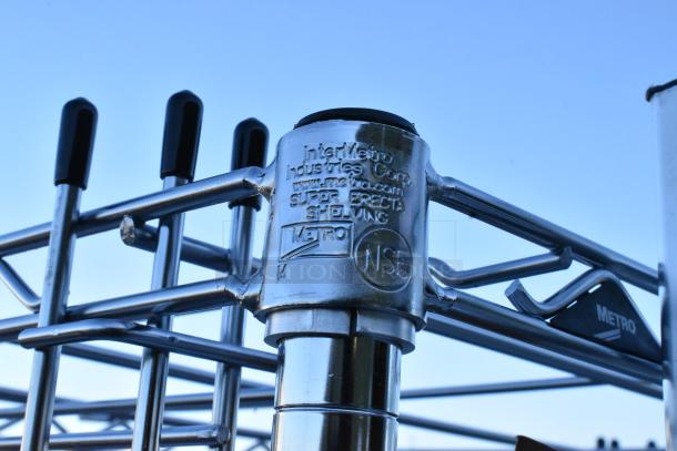 Chrome pan transport rack with commercial casters, labeled "InterMetro Industries Corp" and "Metro NSF" for shelving.
