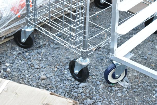 Chrome finish pan transport rack on commercial casters, featuring sturdy wire design and smooth-rolling wheels for easy mobility.