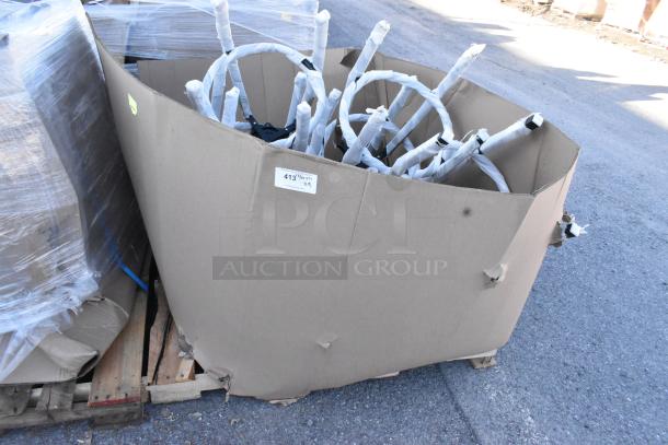 Cardboard box on pallet with stool frames wrapped in protective material. Box labeled "413" and shows signs of wear.