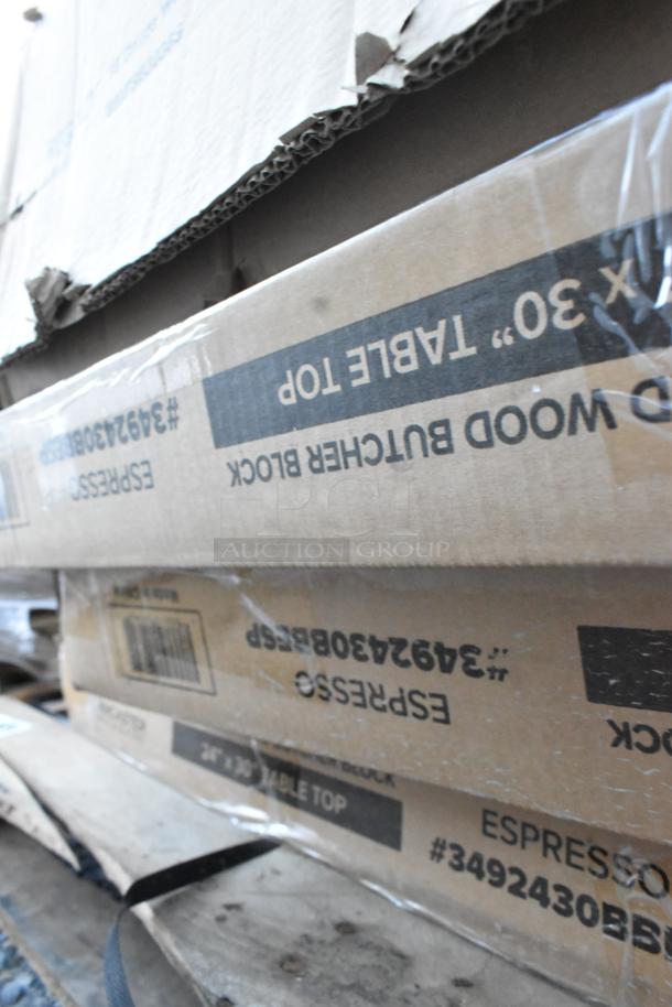 Boxes of brand new scratched and dented items, including Ashland grease trap and tabletops, labeled "Espresso, 26x30 Table Top."