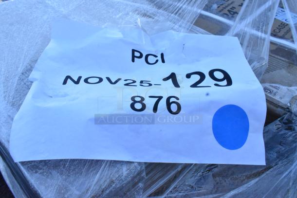 Auction item label reading "PCI NOV25-129 876" on wrapped package. Contains 30 new scratch and dent items, including wine rack.