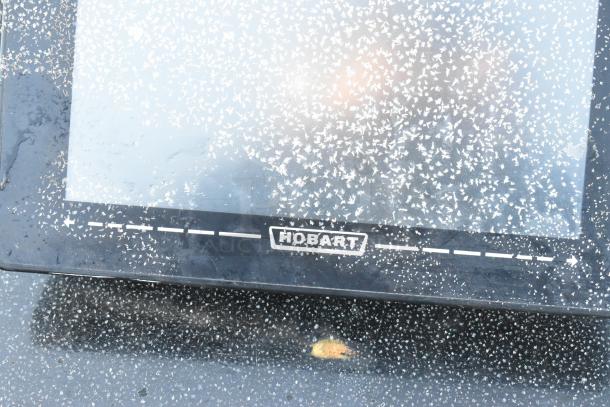 Hobart HTi-LH countertop scale with visible logo, designed for 120/208-240 volts, 1 phase. Surface shows wear.