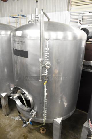 Stainless steel 8.75 BBL beer tax determination tank with clear markings, gauges, and valves. Used for commercial brewing.