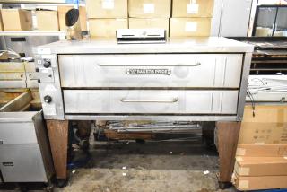 Bakers Pride 4151 Stainless Steel Commercial Natural Gas Powered Single Deck Pizza Oven on Legs. 70,000 BTU. - Item #1226617