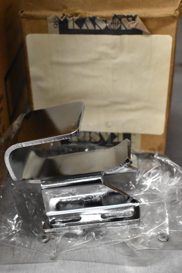 Chrome Kason door catch, brand new with visible scratches, wrapped in plastic beside a Kason box.