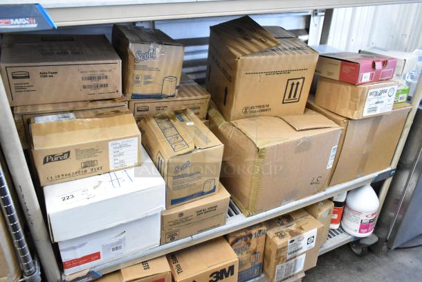 Alt text: Boxes of Rubbermaid Auto Foam refills, Aqua Sparkle detergent, Dymo label printer on metal shelves. Various brands visible.