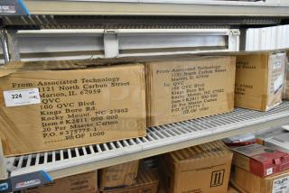 Six boxes on a shelf, including Betco Emulsinator Non Rinse Stripper. Box marked with K2811 000 000, 20 per master carton.