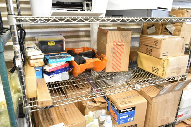 Assorted items on metal shelving, includes phone cases, cords, cleaner bottles, and bags. Various boxes and bags visible.